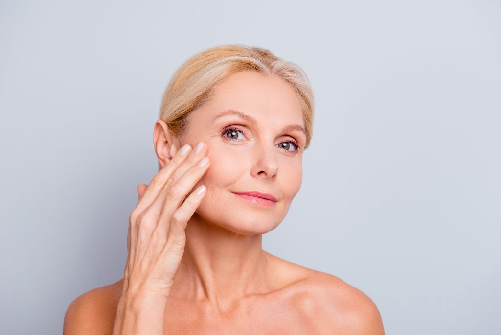 Middle age woman checking her face